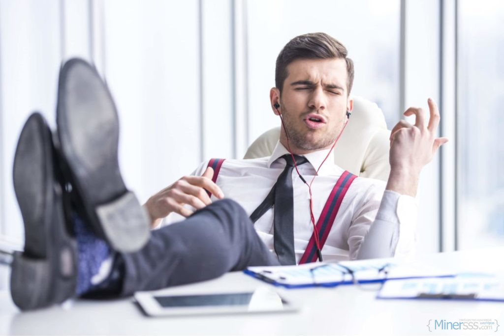 young man in suit listening to music in office doing air guitar 1068x713 1